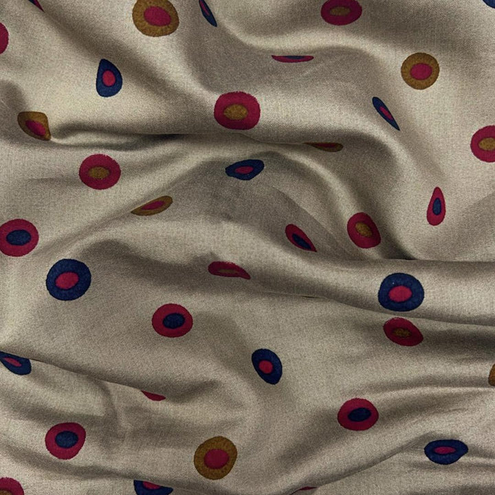 Cream muslin fabric featuring multi-shaded dots in red and blue