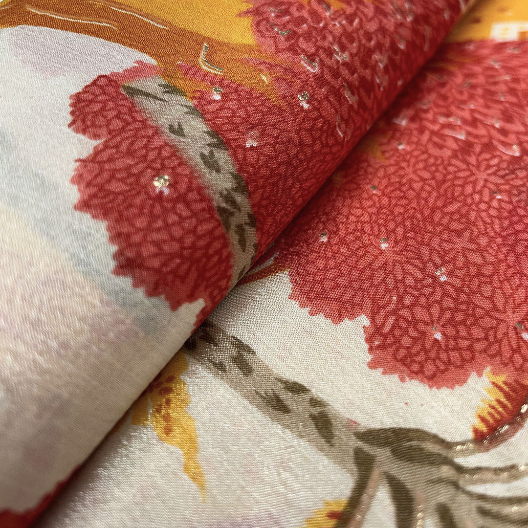 Abstract artistic print on orange chinnon fabric, blending rich shades for a bold fashion statement at Fabrics @StudioLCX.