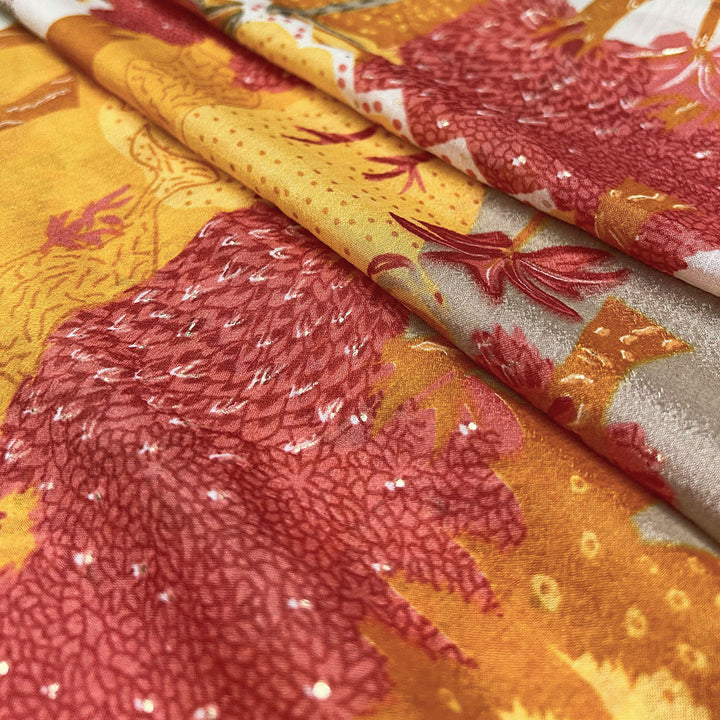 Abstract artistic print on orange chinnon fabric, blending rich shades for a bold fashion statement at Fabrics @StudioLCX.