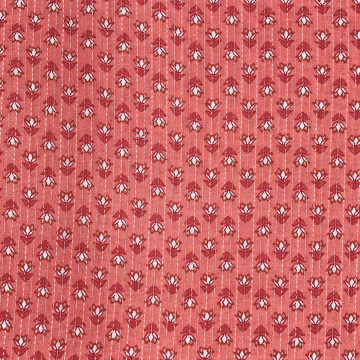 Soft pinkish-orange cotton fabric adorned with small floral Kantha stitching, offering a touch of artisanal beauty at Fabrics @StudioLCX.