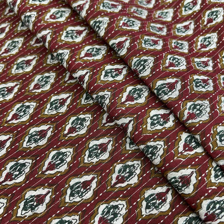 Traditional maroon shade floral cotton Kantha fabric, exuding cultural richness and artisanal charm for bespoke clothing.