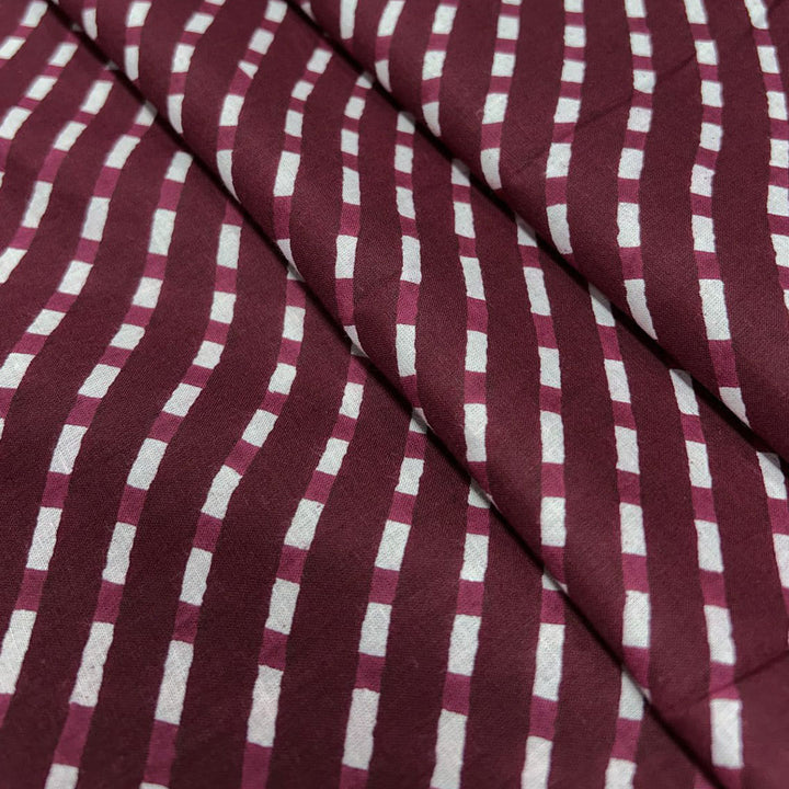 Classic maroon with white stripe pattern on soft cotton fabric, ideal for creating stylish and comfortable clothing.