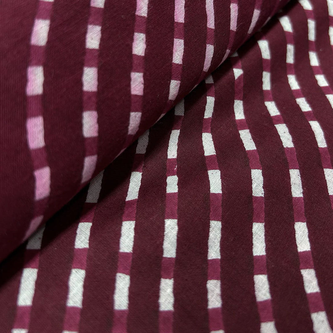 Classic maroon with white stripe pattern on soft cotton fabric, ideal for creating stylish and comfortable clothing.