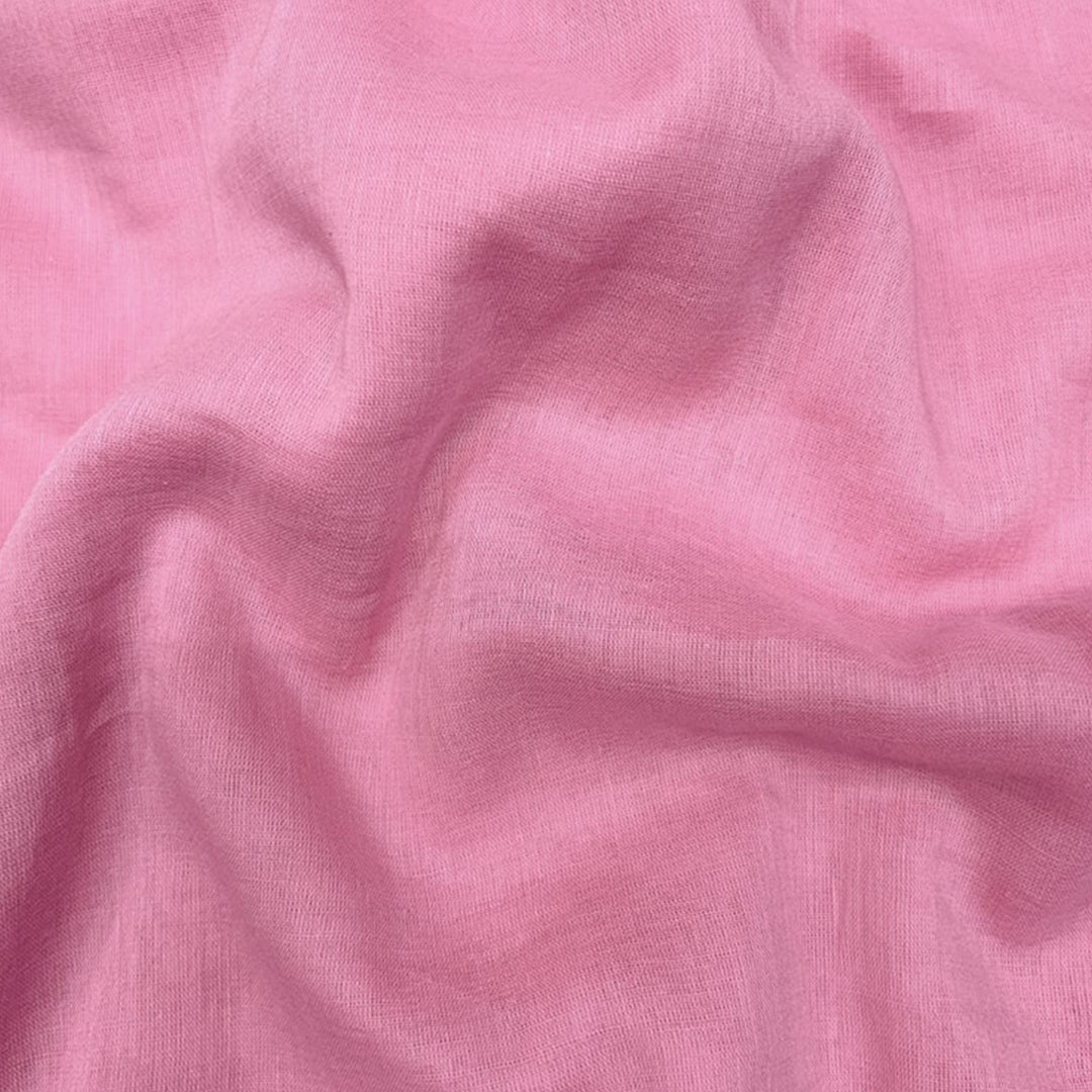 Bright neon pink Mul Mul cotton fabric, smooth and airy, perfect for comfortable and stylish garments at Fabrics @StudioLCX.