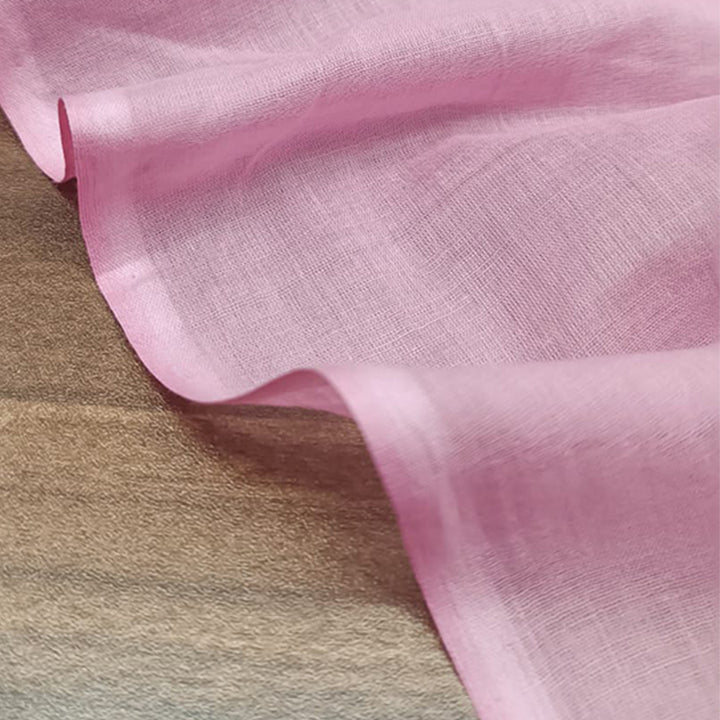 Bright neon pink Mul Mul cotton fabric, smooth and airy, perfect for comfortable and stylish garments at Fabrics @StudioLCX.