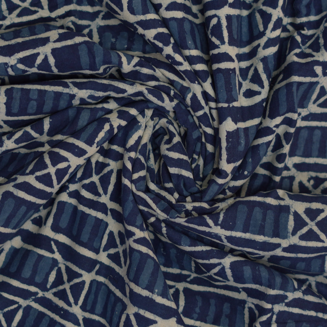 Handblock printed geometric patterns in blue and white on Dabu cotton fabric