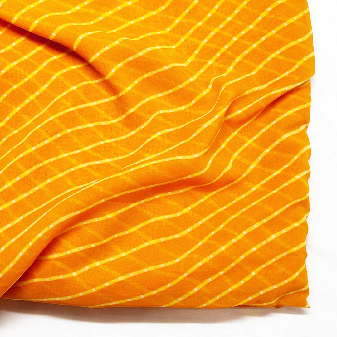 Bright mango-colored georgette fabric with playful stripes, creating a breezy and bold statement for summer outfits.