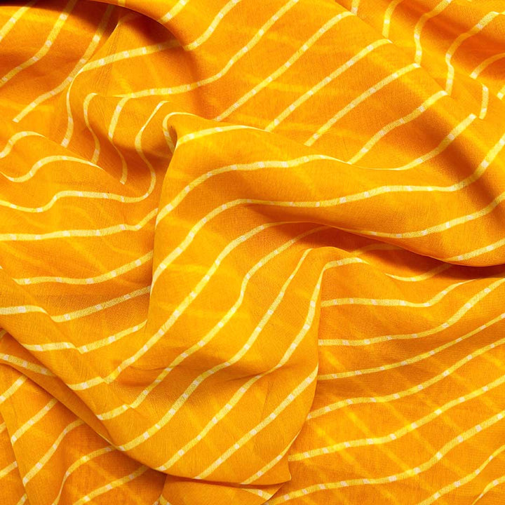 Bright mango-colored georgette fabric with playful stripes, creating a breezy and bold statement for summer outfits.