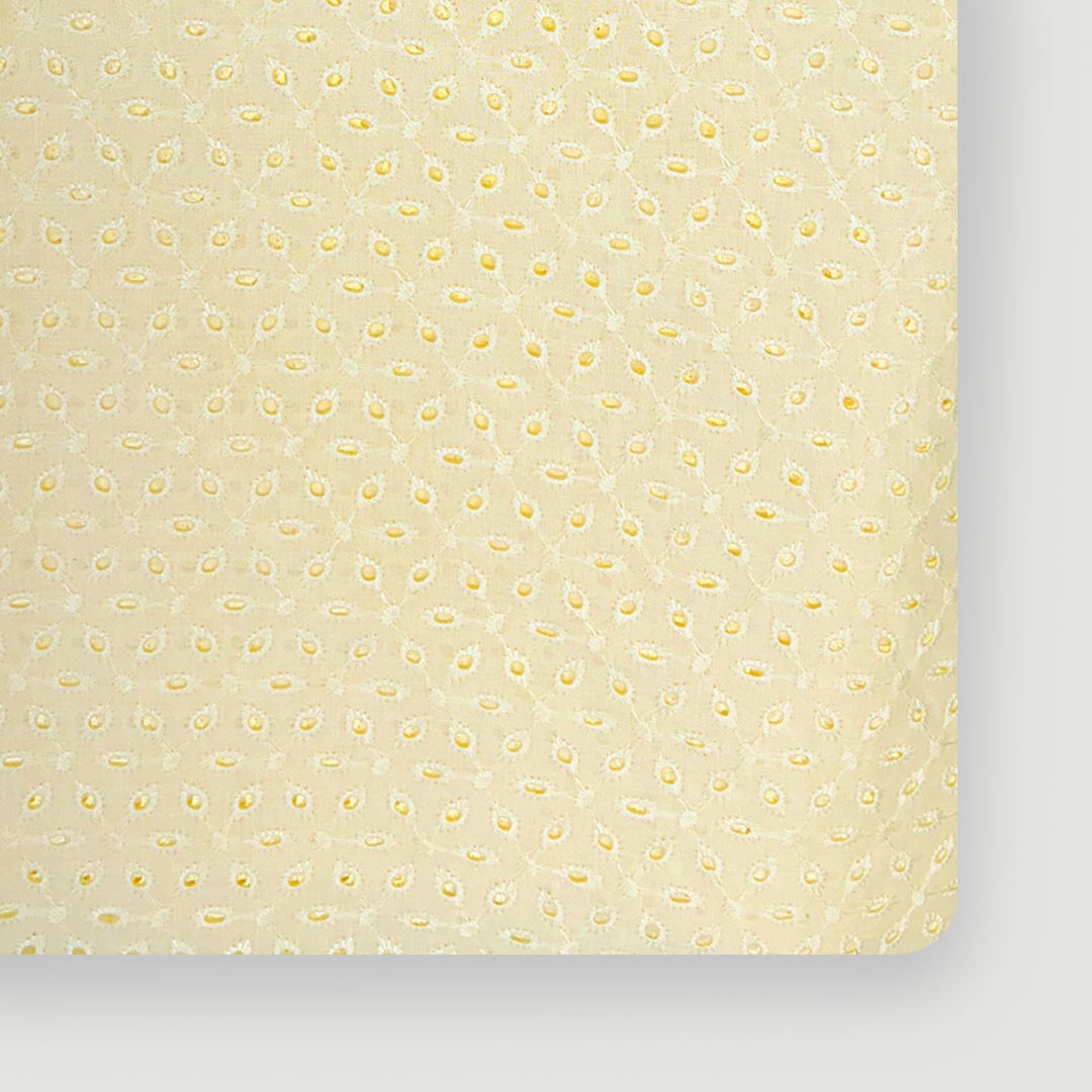 Soft light yellow cotton hakoba fabric with intricate embroidery, offering a fresh and cheerful appeal for exclusive garment creation.