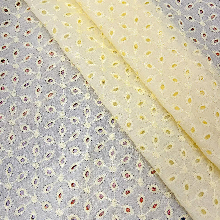 Soft light yellow cotton hakoba fabric with intricate embroidery, offering a fresh and cheerful appeal for exclusive garment creation.