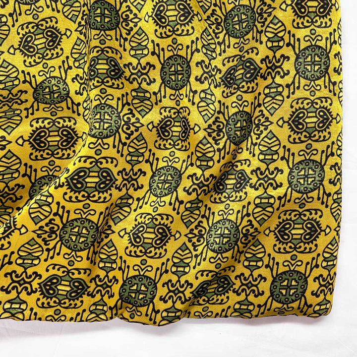  Exotic golden Mashru silk adorned with intricate black Patola Ajrakh prints