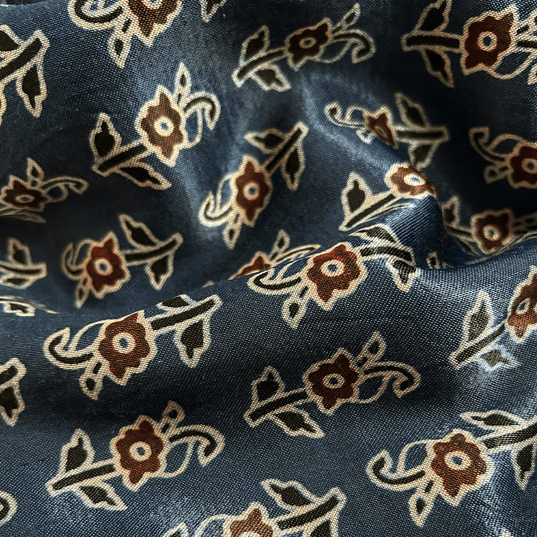 Ocean blue Mashru silk adorned with delicate floral Ajrakh patterns, ideal for refined and elegant apparel at Fabrics @StudioLCX.