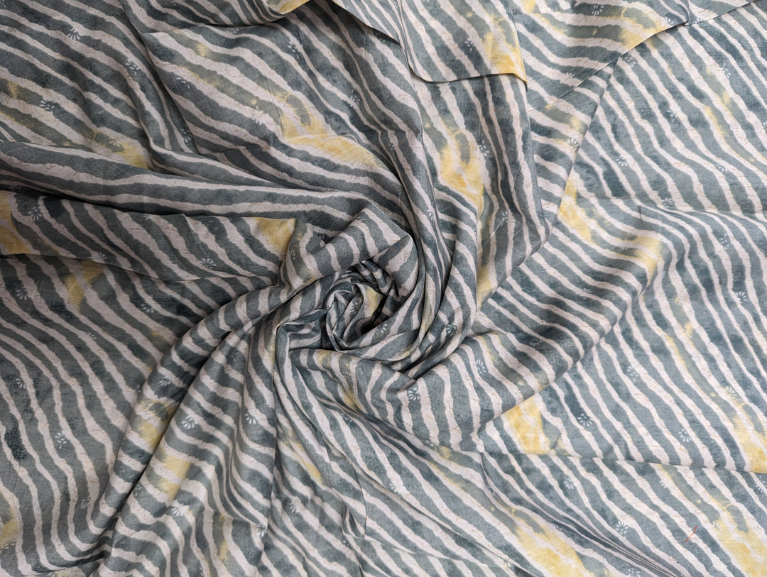 Airy muslin fabric featuring a modern grey geometric print with yellow accents