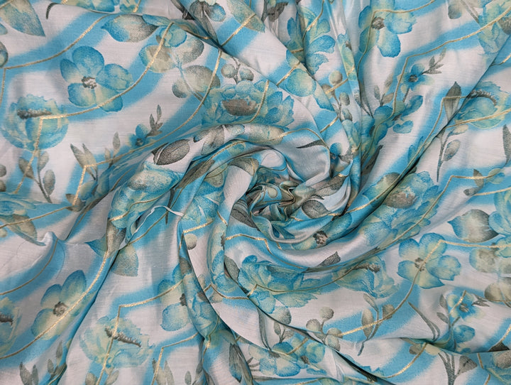 Elegant blue muslin fabric with white floral print for stylish creations