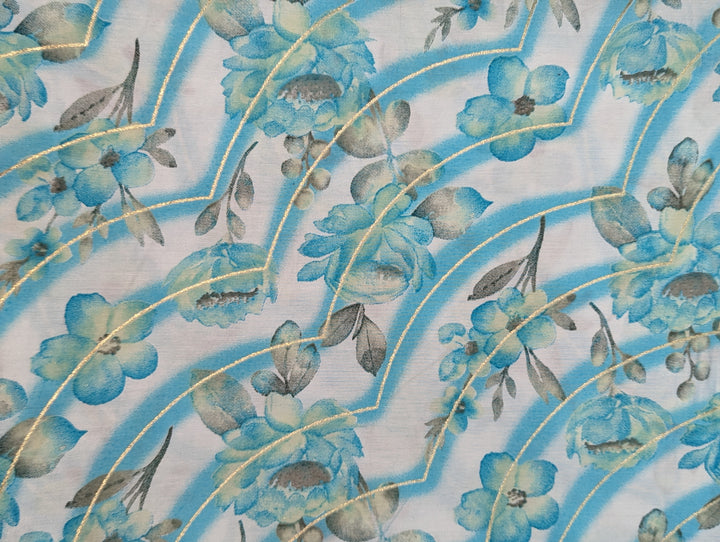 Elegant blue muslin fabric with white floral print for stylish creations