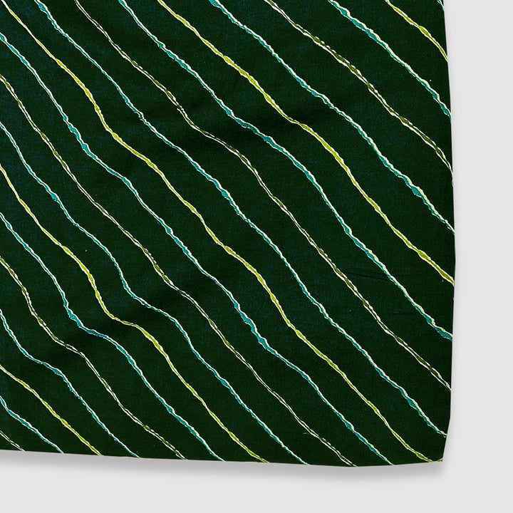 Luminous dark peacock green muslin fabric with leheriya wave patterns and gold accents