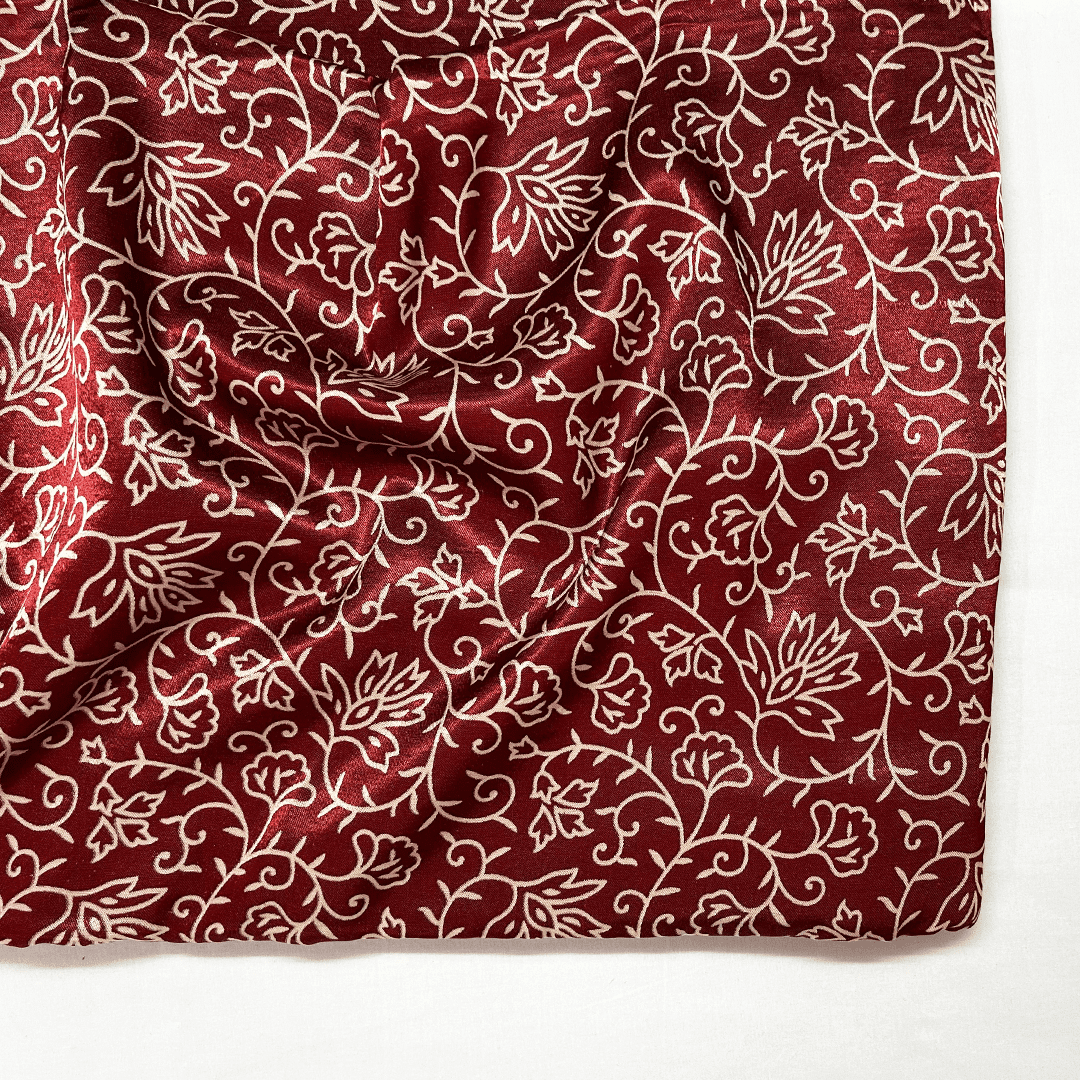 Luxurious maroon floral patola printed ajrakh mashru silk fabric, perfect for exclusive and traditional attire.