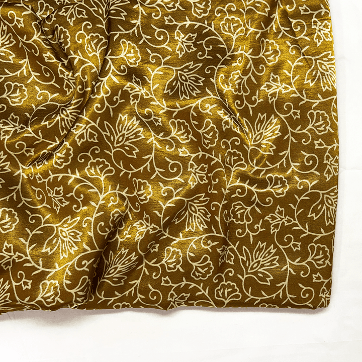 Opulent golden Mashru silk fabric featuring intricate cream floral prints