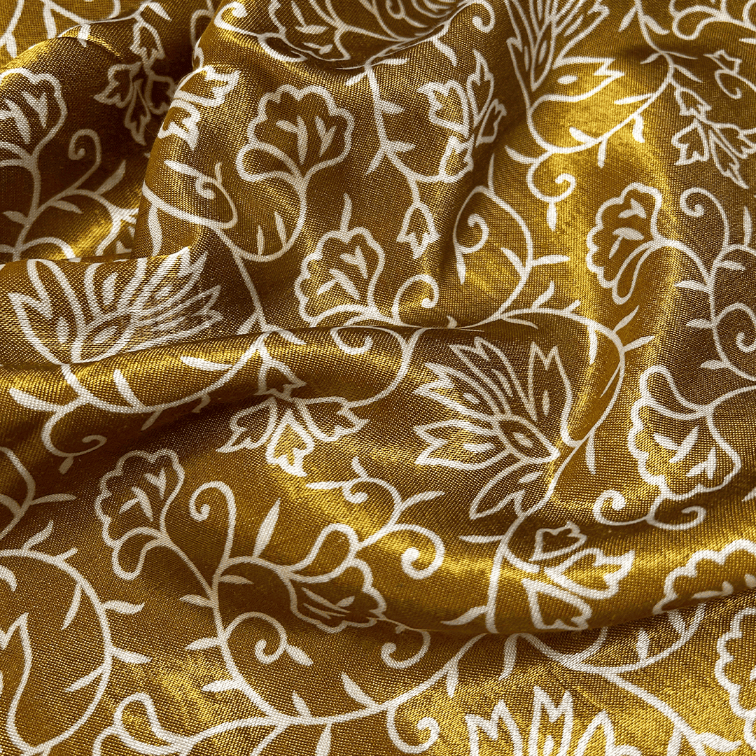 Opulent golden Mashru silk fabric featuring intricate cream floral prints