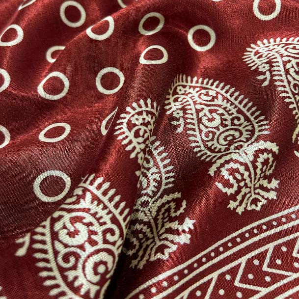 Rich maroon Mashru silk featuring a detailed Patola print, blending traditional motifs with luxurious fabric for distinguished wear.