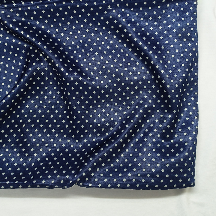 Chic navy blue georgette fabric with playful white polka dots, ideal for stylish garments at Fabrics @StudioLCX.