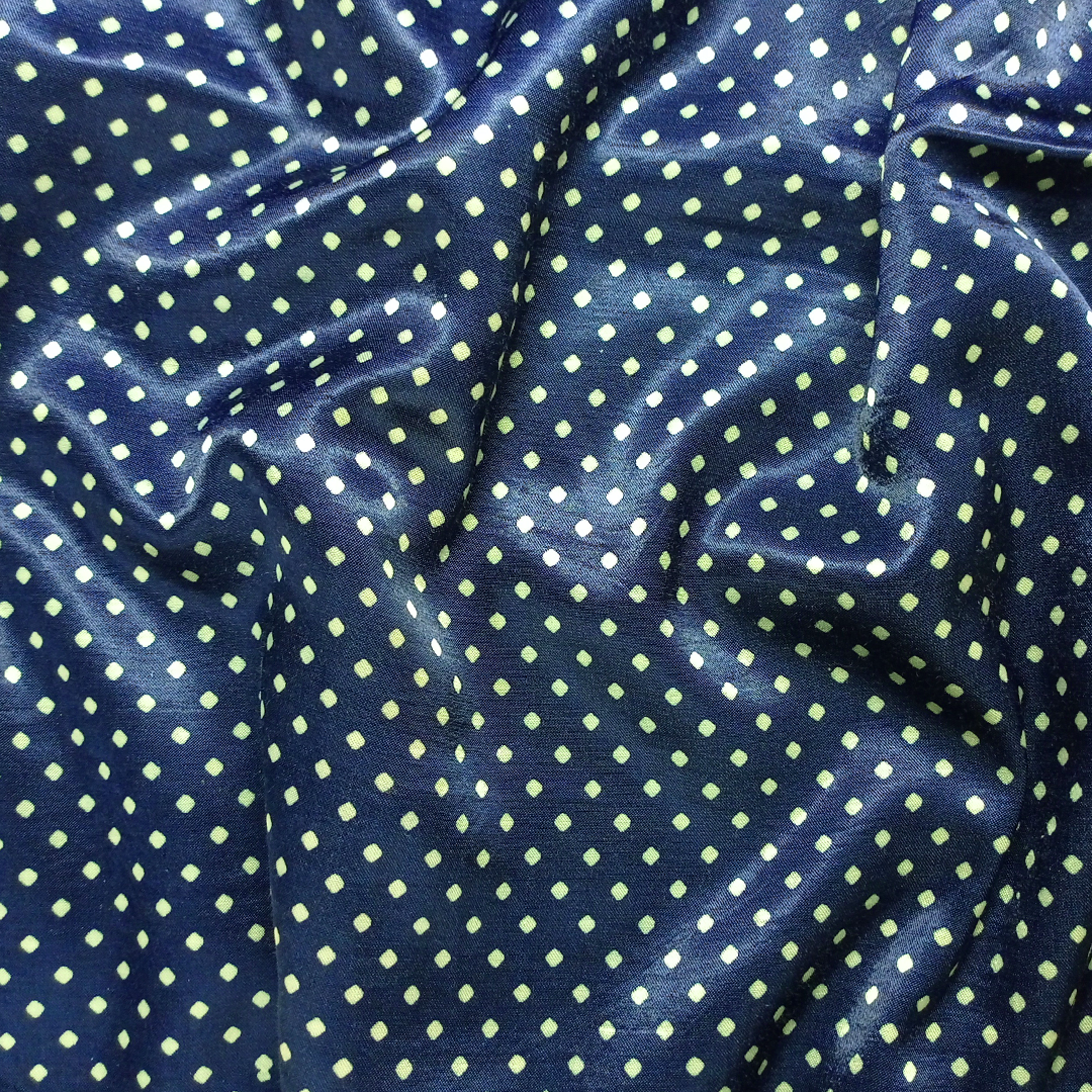 Chic navy blue georgette fabric with playful white polka dots, ideal for stylish garments at Fabrics @StudioLCX.