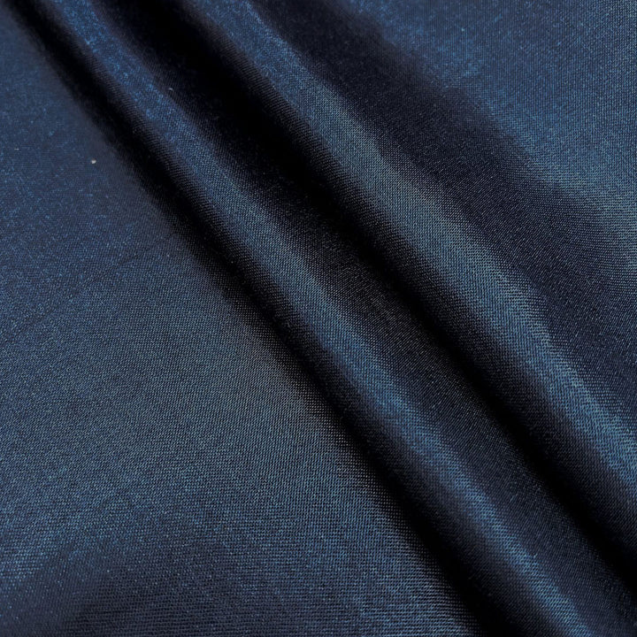 Luxurious navy blue plain Mashru silk fabric, ideal for creating elegant and refined garments with a smooth texture.