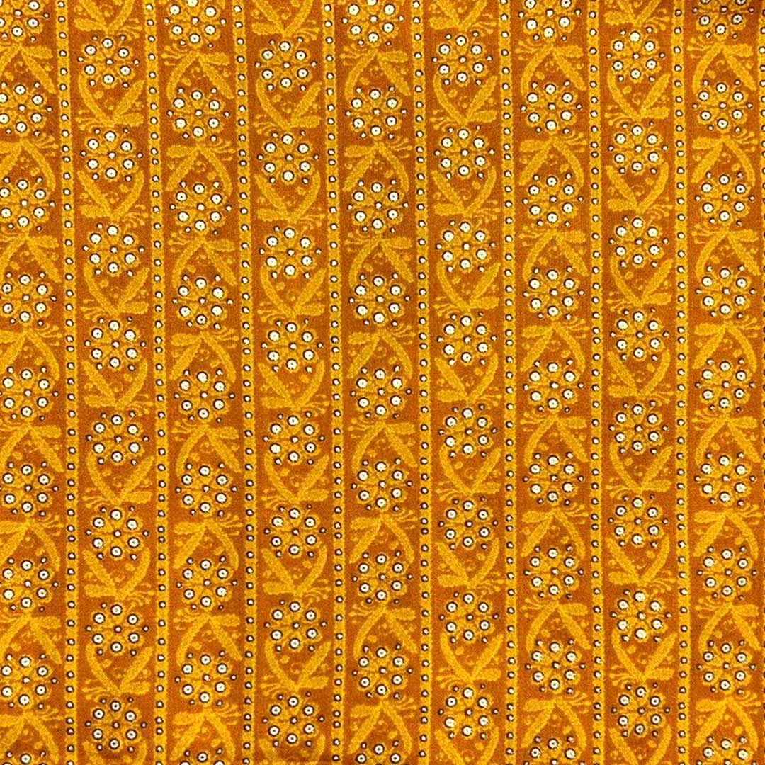 Mustard yellow rayon fabric featuring delicate floral prints, perfect for crafting vibrant and airy fashion pieces.